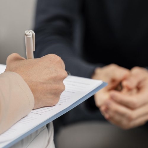 mid-shot-woman-therapist-taking-notes-clipboard-scaled mid-shot-woman-therapist-taking-notes-clipboard-scaled